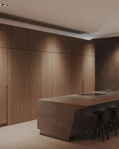 Modern kitchen with marble countertops and wooden cabinets.