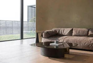 Modern living room featuring a brown sofa and glass coffee table.