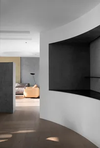 Modern living room featuring a wooden floor and concrete walls.