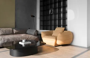 A modern living room with a yellow sofa, dark gray sofa, and black coffee table.