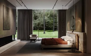 A modern minimalist bedroom featuring a white bed with textured cotton fabric bedding, a beige armchair, and marble elements.