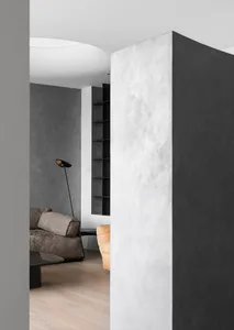 Concrete living room interior with modern furniture and minimalist design elements.