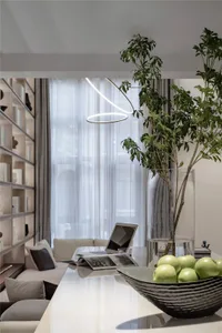 Modern residential interior featuring glass elements, potted plants, and modern lighting.