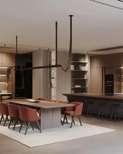 A modern residential kitchen with an open-plan layout, featuring a dining table, chairs, a kitchen island, and bookshelves.