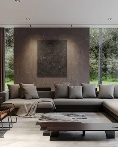 A minimalist living room with concrete walls and a large window