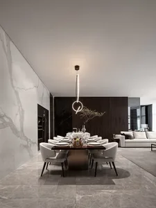 Modern dining room with marble table and chairs, minimalist decor, and sleek design.