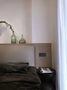 Modern minimalist bedroom with comfortable furniture and elegant decor.