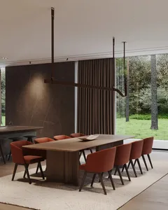 Modern dining room featuring wooden furniture and a large table surrounded by orange chairs.