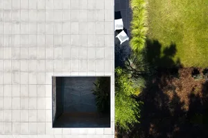 Modern exterior concrete patio with garden view in a minimalist design.