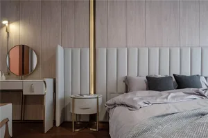 A modern minimalist bedroom with a white upholstered bed, wooden walls, and a round side table.
