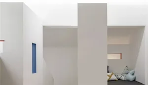 An interior space featuring white walls, wooden panels, and contemporary design elements.