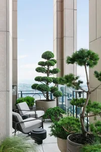 Modern interior balcony with concrete and glass materials and a scenic view.