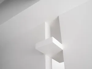 Minimalist modern interior space featuring exposed concrete walls and ceiling.