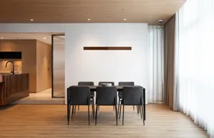 Modern living room with hardwood flooring and minimalist furniture.