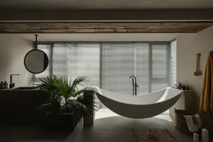 Modern minimalist bathroom with a white concrete bathtub, large windows, and a plant.