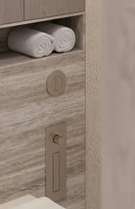 A modern bathroom storage functional zone with a tiled wall and textured surface, featuring a towel storage niche and a toile