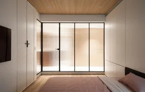 Modern bedroom featuring a window with a view of terrazzo flooring.