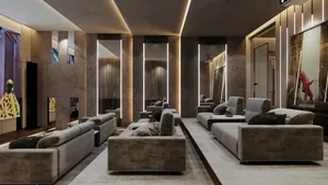 Modern cinema lobby featuring plush velvet couches and textured concrete columns