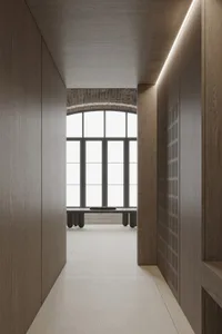 Modern interior design featuring a hallway with wooden paneling and sunlight shining through a large window.