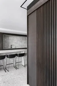 Modern kitchen with dark wooden cabinets and grey marble countertops