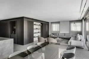 A modern living room with minimalist furniture, cement flooring, wooden panels, and marble accents.