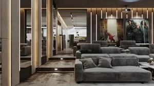 Modern living room with comfortable seating and movie theater posters.