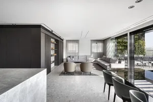 Modern living room featuring a sleek, contemporary design with concrete flooring and minimalistic furniture.