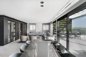Modern living room featuring glass, wood, and concrete materials.