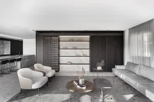 Modern, minimalist living room with marble accents, wooden slat wall, and concrete floor.