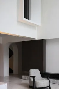 A modern lobby featuring minimalist design with concrete materials.