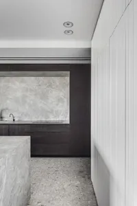 Modern kitchen featuring marble countertops and floor tiles