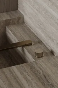 A minimalist bathroom featuring marble surfaces.