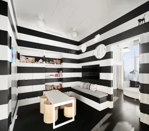 A modern minimalist child playroom featuring black and white striped walls, a built-in seating area, and a table with stools.