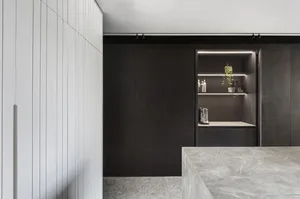 Modern residential kitchen featuring stone and metal materials.