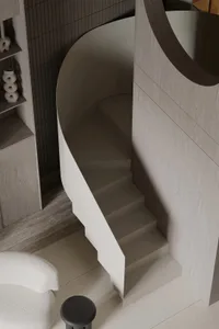 A modern concrete staircase with a circular design.