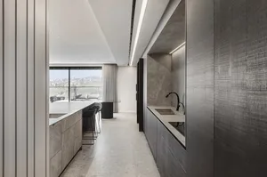 Modern kitchen with industrial design features, showcasing sleek marble countertops and minimalist aesthetic.