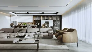 A modern living room featuring a beige sofa, glass coffee table, and minimalist decor.