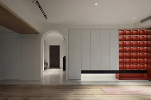 Modern living room with white walls and red accents