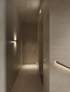 Minimalist design corridor with concrete walls, floor, and ceiling.