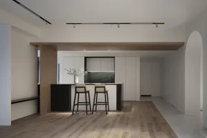 A modern residential kitchen with a concrete countertop and marble accents.