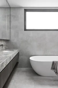 Modern minimalist bathroom with concrete walls, a white freestanding bathtub, and a floating vanity.