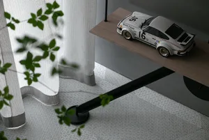 A minimalist display of a white racing car model on a wooden shelf.