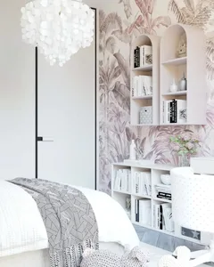Modern bathroom with floral wallpaper, bookshelves, and a chandelier.