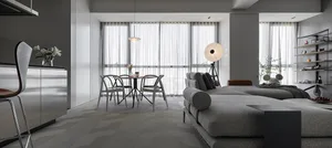 Contemporary living room with gray fabric sofa and dining area by the window.