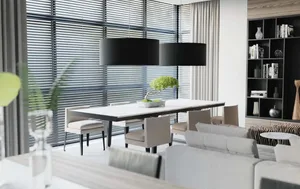 A modern living and dining space featuring minimalist decor, white furniture, and large windows with vertical blinds.