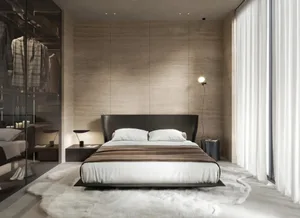 A modern minimalist bedroom with a black bed frame, white linen, and a minimalist design aesthetic.