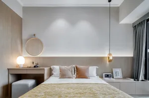Modern minimalist bedroom featuring wooden walls, a neatly made bed with mixed-colored pillows, and a hanging lamp.