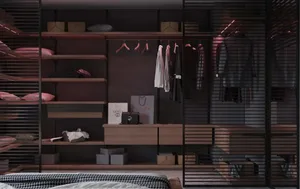 A modern minimalist closet with wooden shelves, metal railings, and clothes hanging on pink hangers.