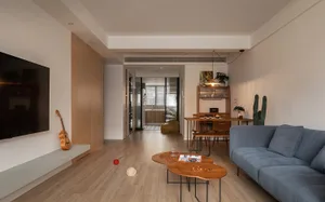 A modern minimalist living room with wooden furniture, including a large blue sofa, coffee tables, and a flat-screen TV.