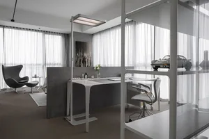 Minimalist modern office with concrete and glass materials.
